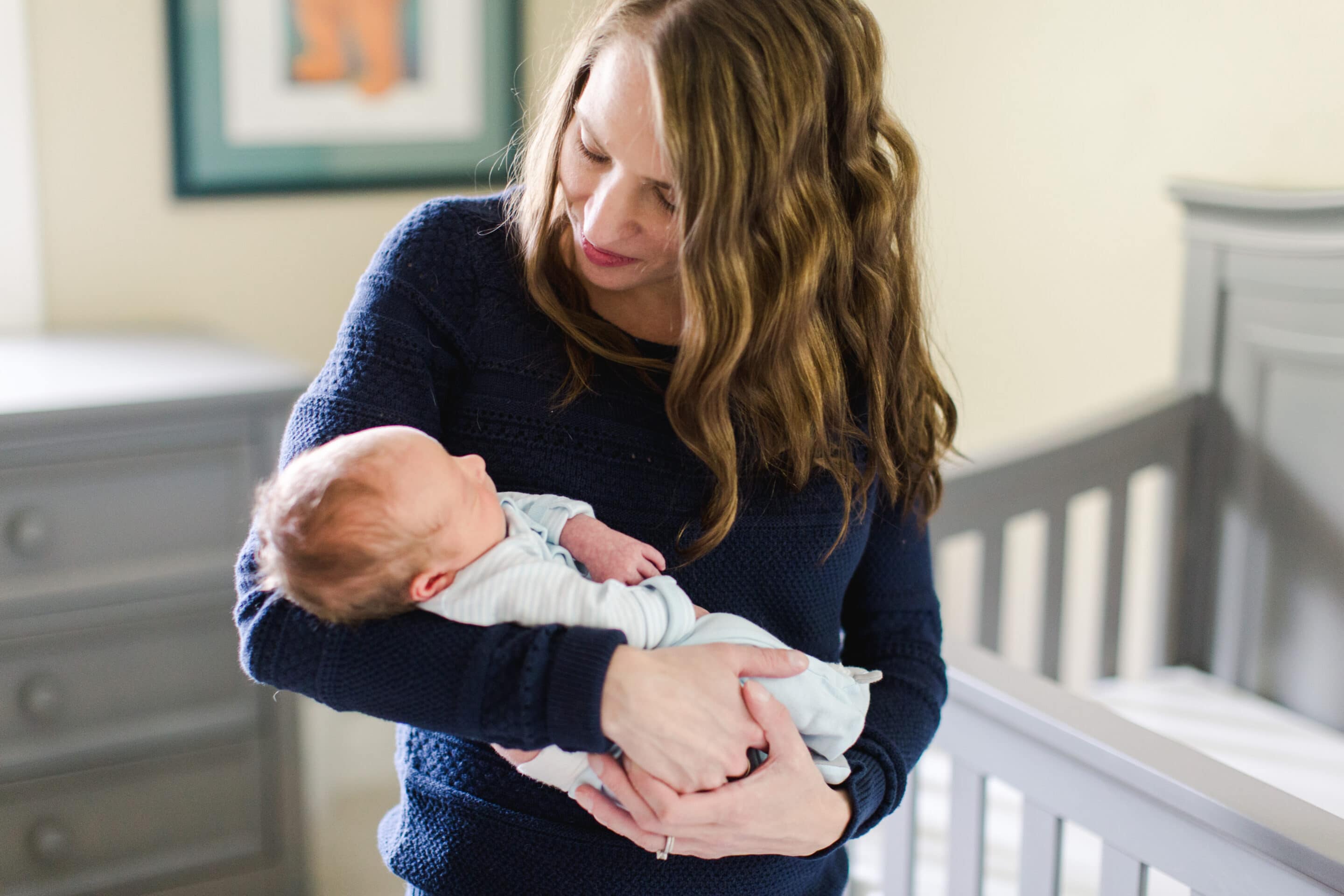 woman-holding-newborn-baby-looking-contently-at-her-child