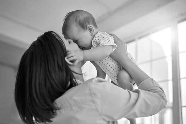 mom-lifting-her-baby-to-her-face-looking-at-peace