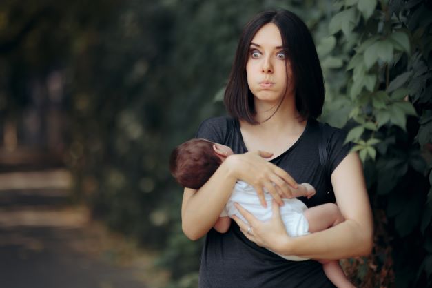 Mom-standing-outside-rocking-baby-looking-overwhelmed