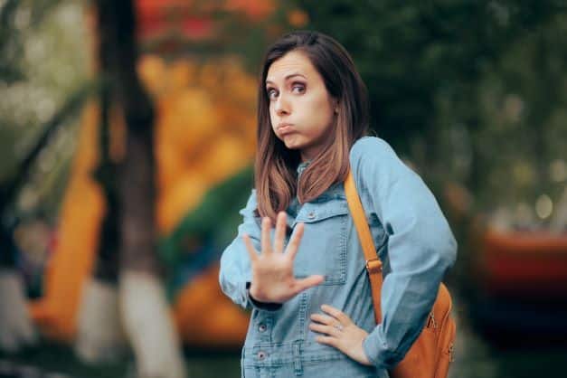 woman-standing-outside-holding-her-hand-out-setting-her-own-boundaries