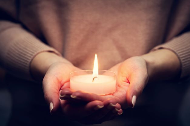 person-holding-a-small-candle