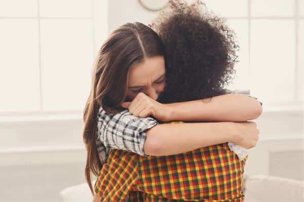 woman-hugging-another-woman-who-is-comforting-her-after-a truamatic-birth