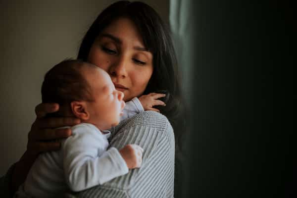 woman-holding-her-baby-trying-to-bond-after-a-birth-trauma